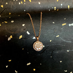 SOLITAIRE: WHEEL OF FORTUNE SPINNING NECKLACE WITH ROUND INCLUSION STONE